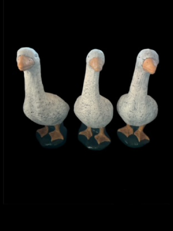 Three ducks in a row yard statues
