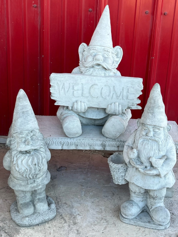 three examples of cement gnomes for the yard