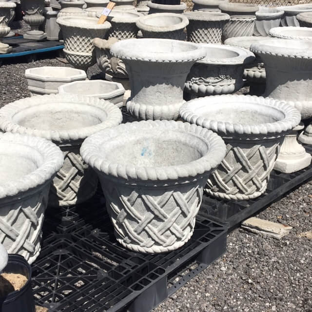 Multiple sizes and styles of cement flower pots