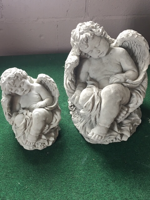 two sizes of cement cherubs